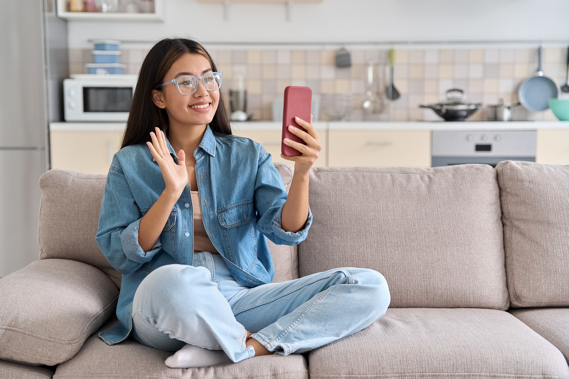 woman video chatting on couch